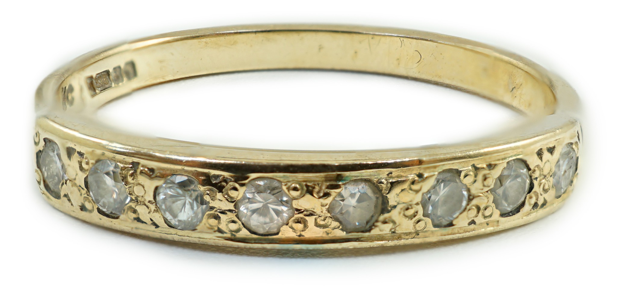 A modern 9ct gold and eight stone diamond chip set half hoop ring, size O, gross weight 1.6 grams.